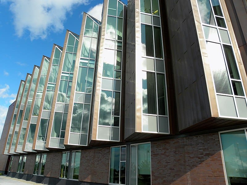 A modern brick building with large windows jutting out at acute angles (the Progress Campus Library of Centennial College)