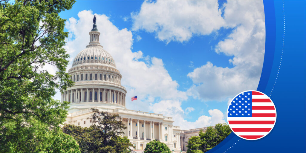 The White House (a large building with a towering dome structure, made of white stone) under a blue sky with clouds. Framed by trees (and an illustrated American flag graphic).