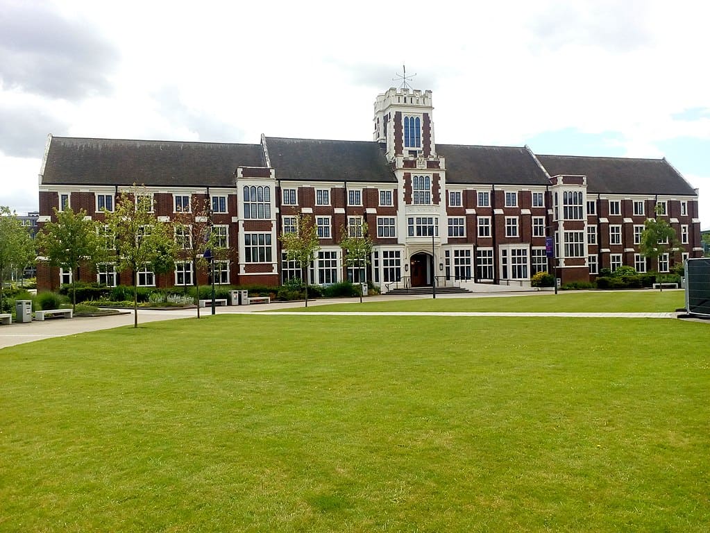 A classic red-brick university building; three storeys, set on a wide green lawn. (Loughborough University, UK)