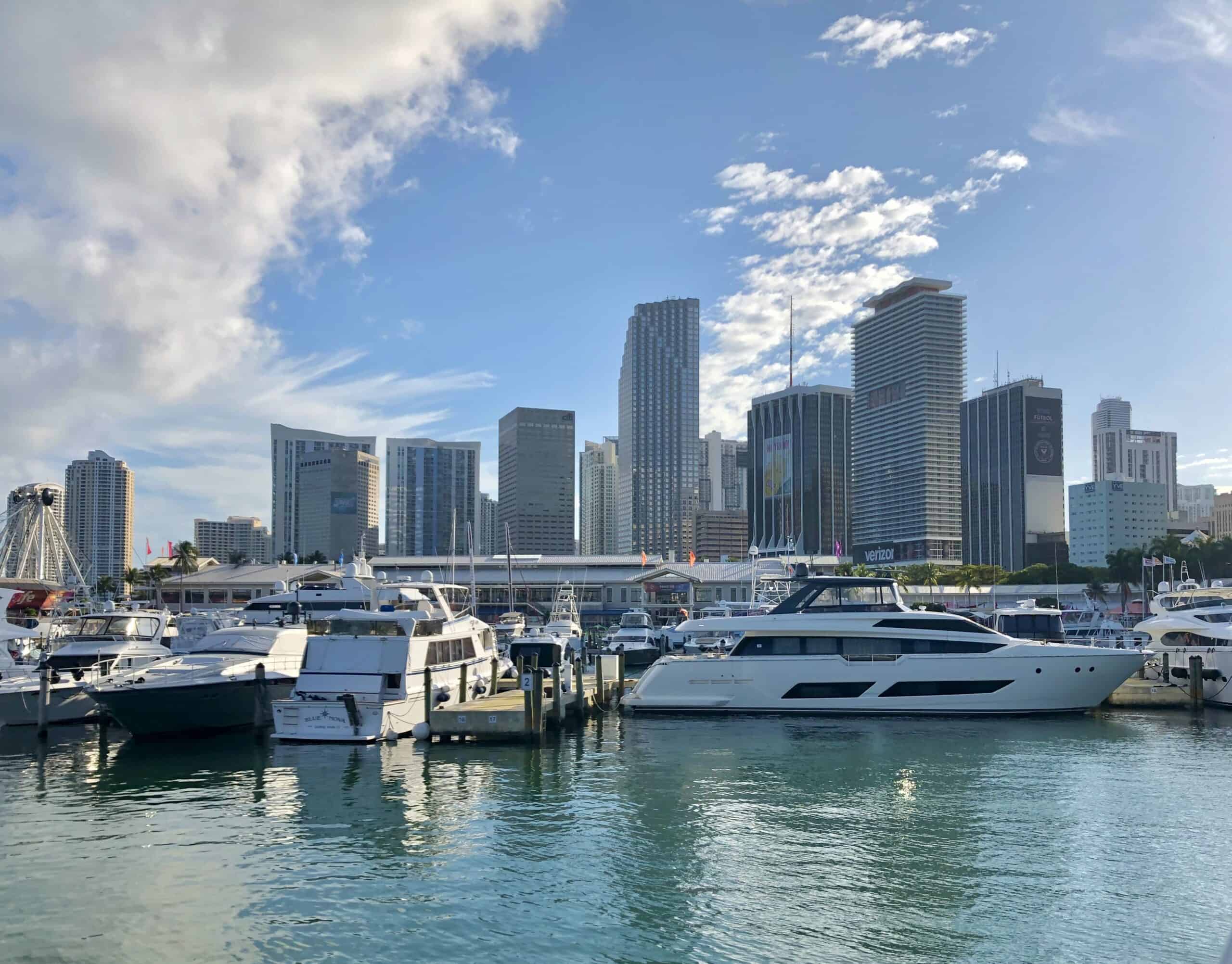 The Miami marina with lots of large boats and its downtown skyline.