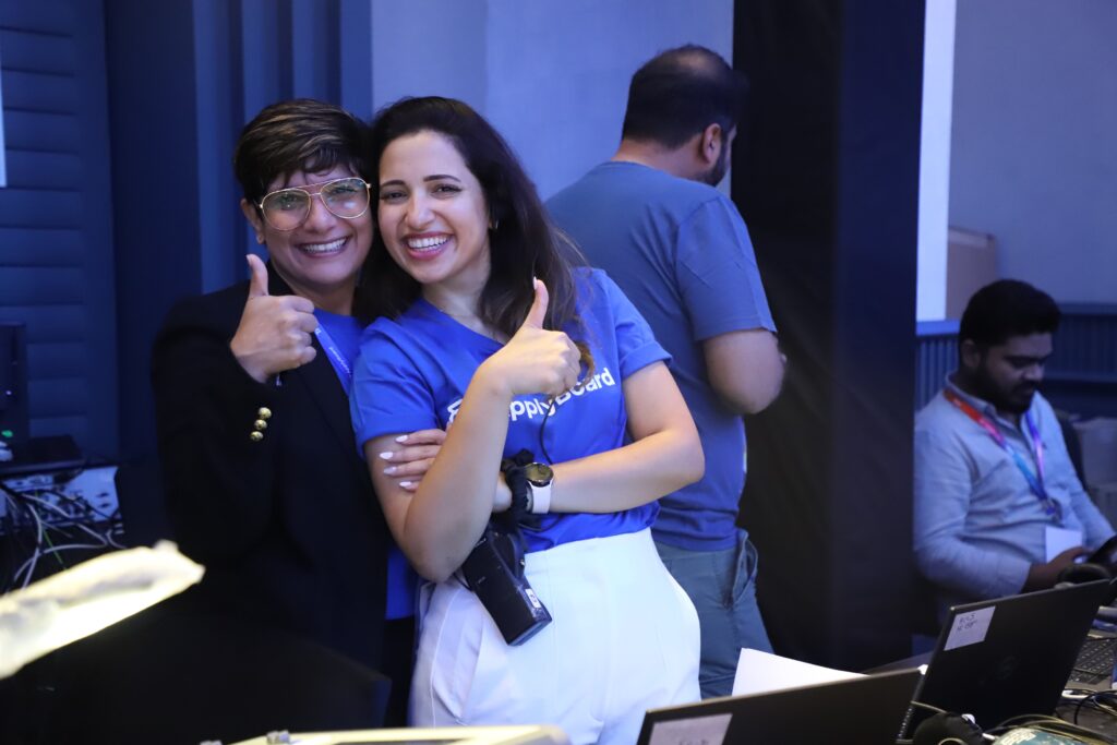 Two members of the ApplyBoard team giving thumbs ups to the camera at TRW 2023.