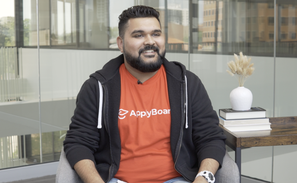 Ankit Agarwal sitting on a chair at Canada HQ during his Core Values in Action: Making Work Fun interview.