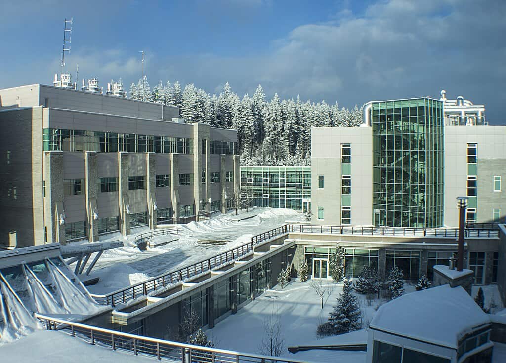Modern multistorey university buildings dusted by snow.